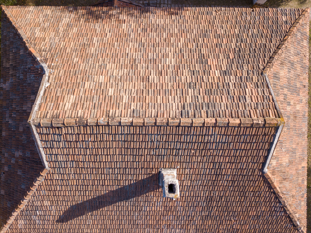 Old,Tile,Roof,Above,The,House,With,High,Chimney,And