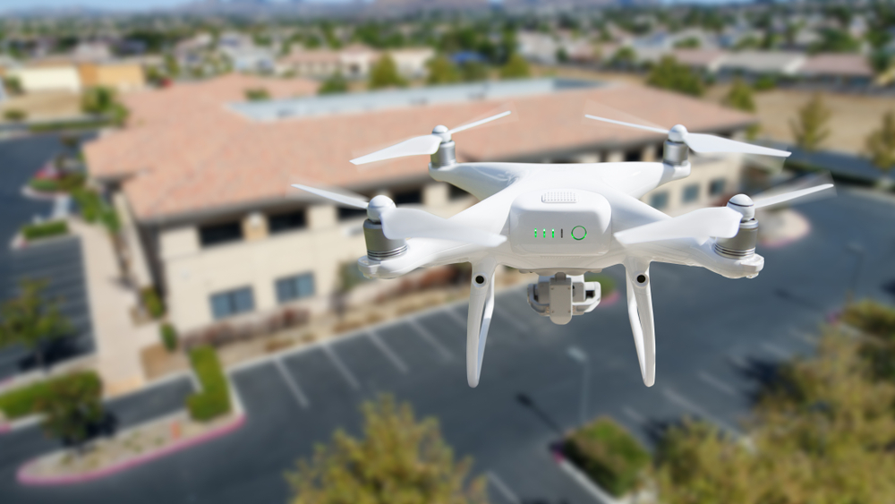 Unmanned,Aircraft,System,Quadcopter,Drone,In,The,Air,Near,Corporate