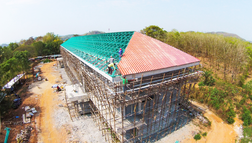 Builder,Worker,Are,Building,Construction,On,Top,Roof,,Image,From